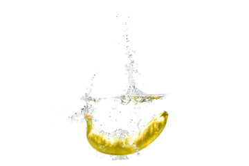 one banana falling into water on a white background with splashes