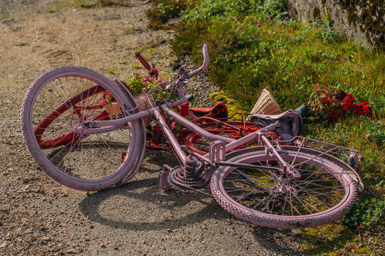 Two painted bicycles  lies on earth