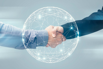 Two Unrecognizable Businessmen Handshaking Over Holographic Earth Globe, Double Exposure