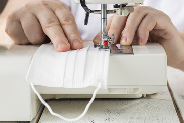 sew the textile face medical mask during coronavirus pandemia with sewing machine. How to make a...