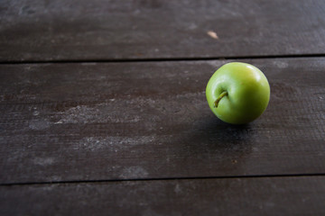 Green apple on wooden vintage table