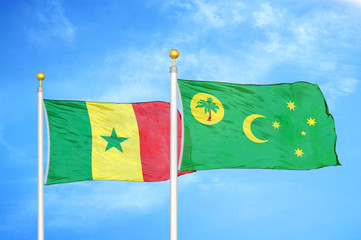 Senegal and Cocos Keeling Islands two flags on flagpoles and blue cloudy sky