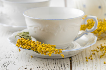 Elegant white porcelain tea set with cups and saucers. Luxury design with porcelain roses.