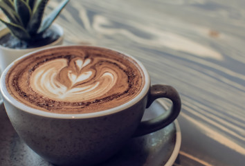 A glass of coffee with milk foam