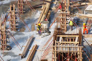 The workers are pouring concrete column