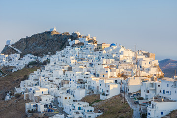 The chora - capital with traditional white houses of Serifos island Aegean Cyclades Greece against a blue sky on sunset