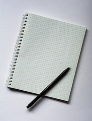 school notebook on a white background, spiral notepad on a table