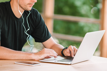 Young man with laptop works from home