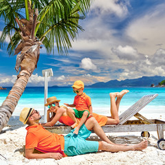 Family with three year old boy on beach. Seychelles, Mahe.