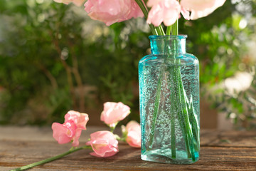 Bouquet of pink sweet peas Lathyrus in beautiful transparent vase on wooden background. Home garden,rustic. Spring concept. International Women's Day, March 8 and Valentine's Day,14 of February
