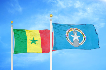 Senegal and Northern Mariana Islands two flags on flagpoles and blue cloudy sky