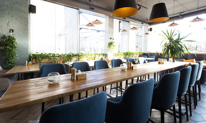 Cozy modern interior of restaurant with empty tables