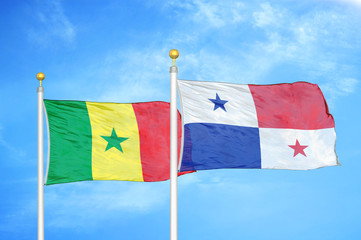 Senegal and Panama two flags on flagpoles and blue cloudy sky