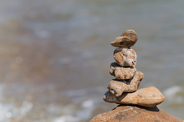 Zen concept. Object made of stone on the beach. Stone pyramid for meditation. Harmony and Meditation. Zen stones.