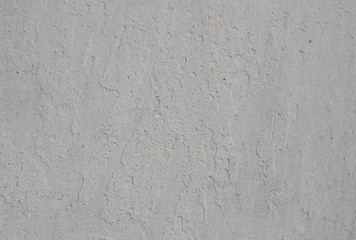 Textured background in gray with small cracks. Old, dirty paint silver color with a heterogeneous convex structure.