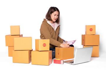 Asian women wear yellow robes. Review orders from customers on laptops and mobile phones. On an isolated white background Online business and delivery concepts