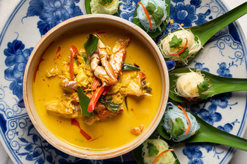 Close up of yellow curry with crab meat and rice noodle. Traditional food of Phuket Thailand.