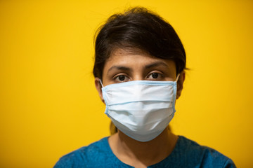 A young girl wearing a surgical facemask. 