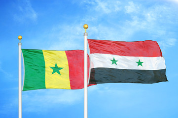 Senegal and Syria two flags on flagpoles and blue cloudy sky