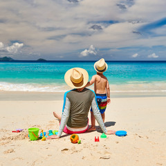 Toddler boy on beach with father