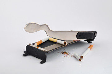 Photo guillotine cut the cigarette. Isolated on a white background