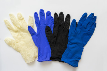 Medical surgical gloves in different colors, on a white background