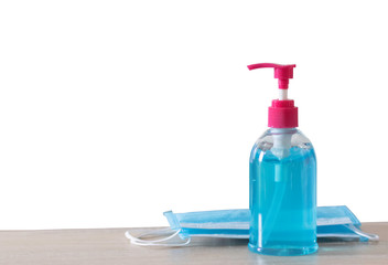 The blue alcohol gel bottle is placed on the right side with the mask. On the table and the white wall Alcohol Hand washing Anti-virus and anti-virus Covid-19 Copy space