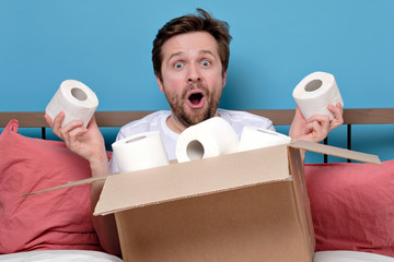 Mature man receiving his order from online shop with toilet paper at home.