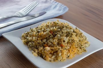 Fragrant pilaf with meat and vegetables close up on a plate