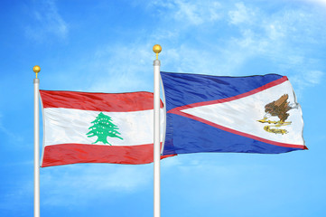 Lebanon and American Samoa two flags on flagpoles and blue cloudy sky