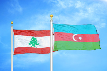 Lebanon and Azerbaijan  two flags on flagpoles and blue cloudy sky