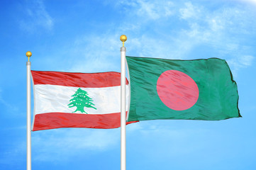Lebanon and Bangladesh  two flags on flagpoles and blue cloudy sky