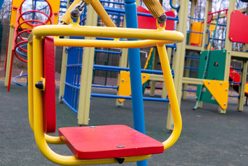 Sitting a baby swing in a deserted empty playground in the city 's recreation park during the coronavirus quarantine period