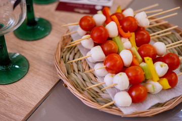 canapes of mozzarella and cherry tomatoes and celery on a table, appetizer