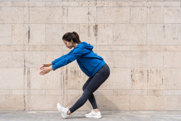 Fototapeta premium A young Asian woman is doing warm-up exercises