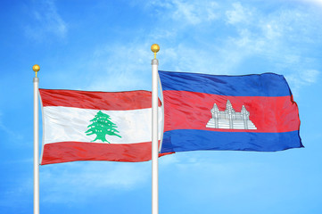 Lebanon and Cambodia  two flags on flagpoles and blue cloudy sky