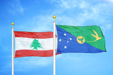 Lebanon and Christmas Island two flags on flagpoles and blue cloudy sky