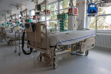 Intensive care unit in hospital, beds with monitors an ventilators, a place where they are treated...