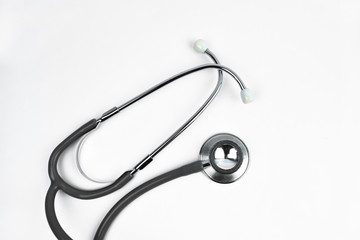 A medical users stethoscope nicely placed over a white isolated background