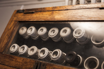 Naklejka premium Vintage electrical fuses mounted on a dark panel