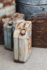 Old rusty German jerrycans, vertical photo