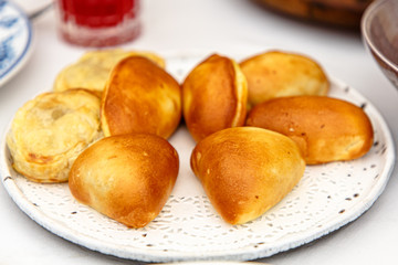 Different pies with different fillings are on the plate.