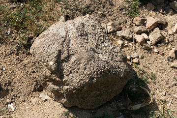 Large gravel from the mountains that are outdoors on the ground.
