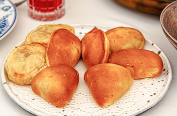 Different pies with different fillings are on the plate.