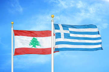 Lebanon and Greece two flags on flagpoles and blue cloudy sky