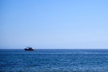 small boat in the ocean                 
