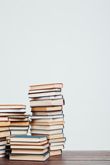 many stacks of educational books at home preparing for exams on a white background