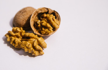 Walnut on a white background. Split nut close-up. Whole kernel of the nut. Photo of food.