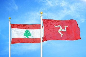 Lebanon and Isle of Mann two flags on flagpoles and blue cloudy sky
