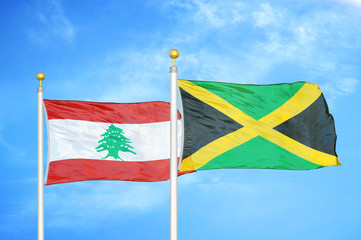 Lebanon and Jamaica two flags on flagpoles and blue cloudy sky